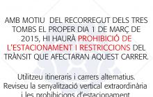 Cartell d'avís del dispositiu dels Tres Tombs a les portes dels immobles
